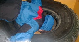 Michael with his head in a pile of tires